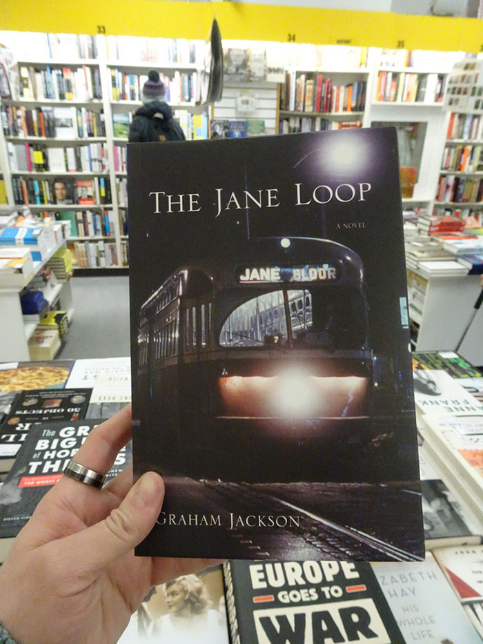 Cover of The Jane Loop by Graham Jackson in a bookstore.
